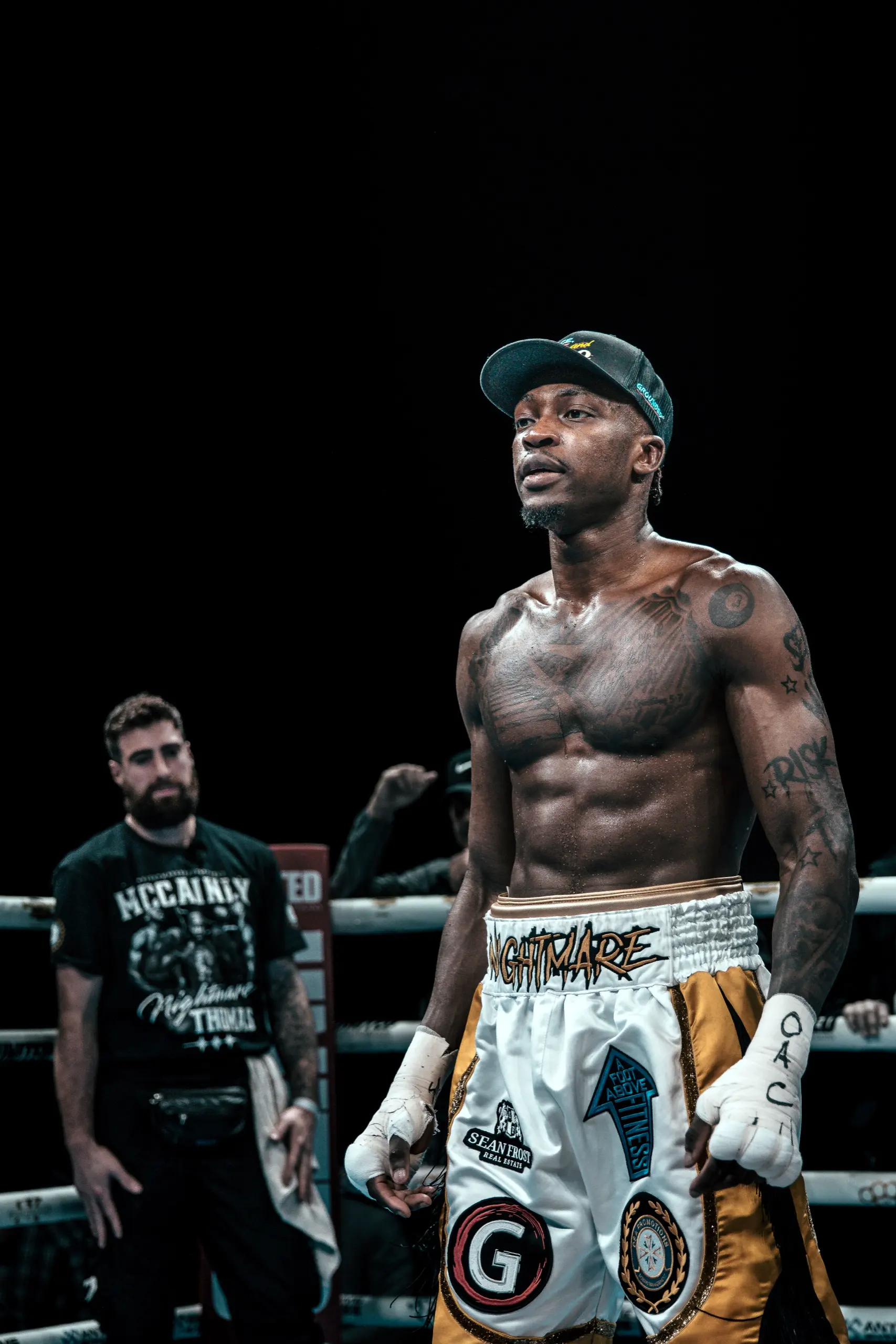 Thomas after the fight with his coach watching from the corner