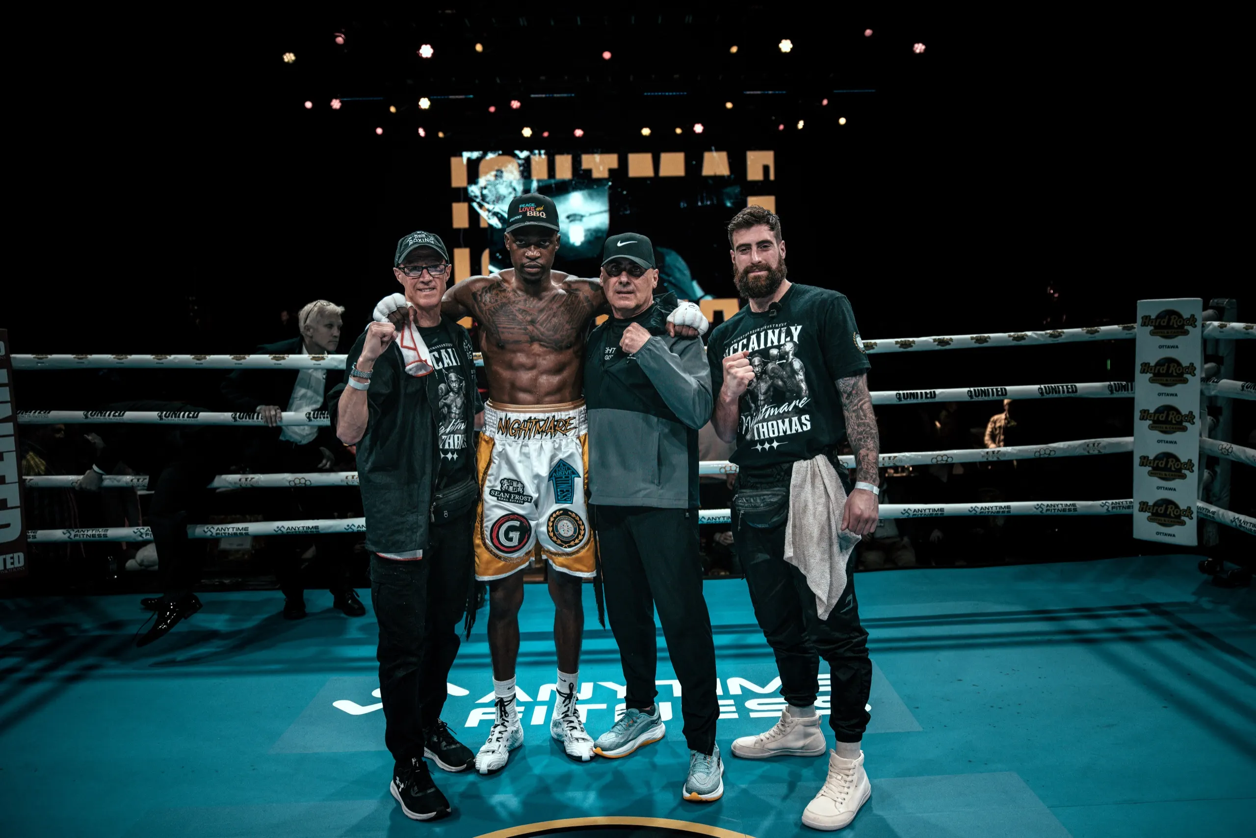 Mccainly Thomas with his coaching team inside the ring after the fight